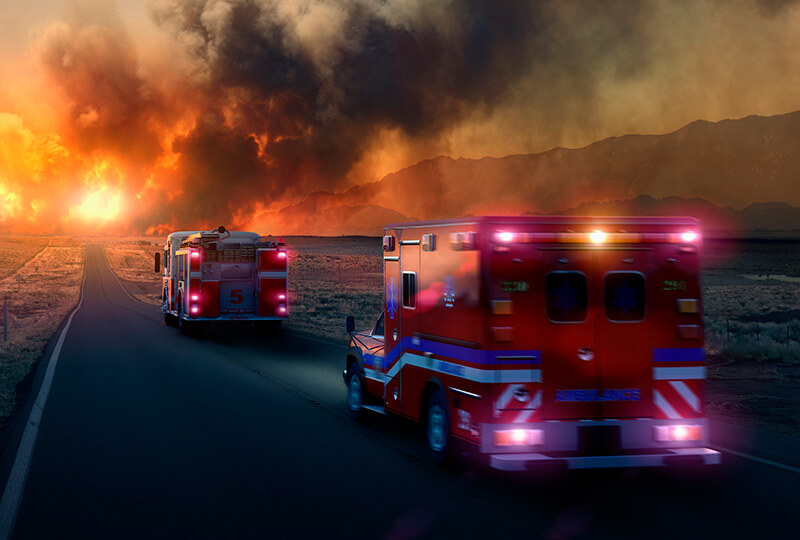 Ambulance and fire truck driving towards emergency