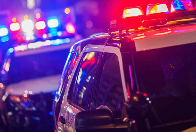 Police vehicles with their lights on